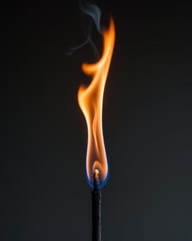 a fire flame on a black background with a black background photo