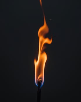 A lit matchstick with flames on it photo