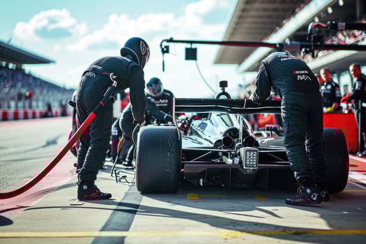 A man is working on a race car photo