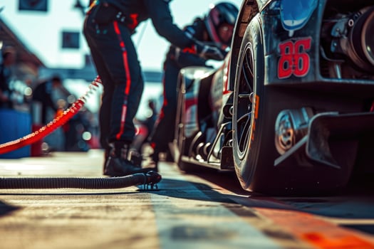 A man is standing next to a race car photo