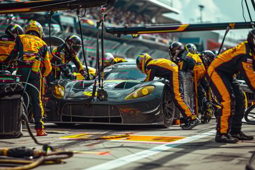 A group of men working on a race car photo