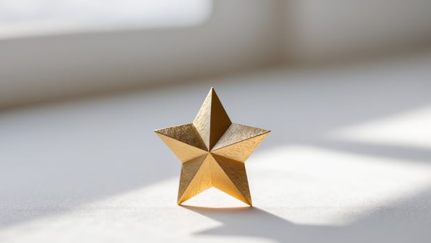 a close up of a gold star on a white surface photo