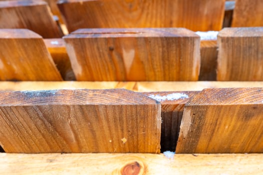 Wooden blocks arranged neatly, showcasing craftsmanship and natural texture in a workspace photo