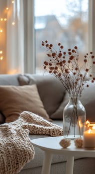 A cozy living room with a candle and a vase of flowers photo