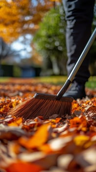 Sweeping vibrant autumn leaves in a tranquil park setting during a sunny afternoon photo