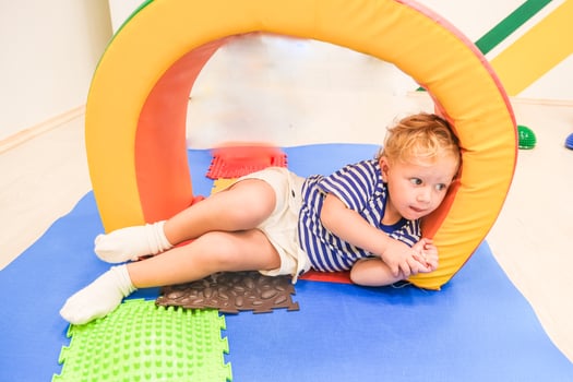 Beautiful blonde baby girl playing in kindergarten photo