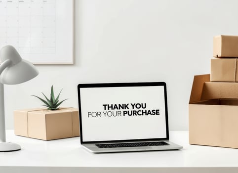 Thank you message displayed on laptop with cardboard boxes in a modern office workspace for recent purchase confirmation photo