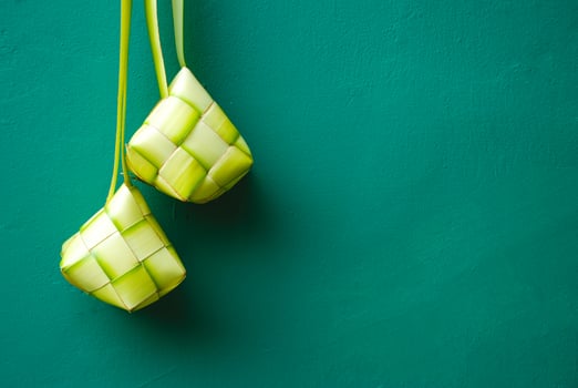 Ketupat is a traditional Indonesian food made from rice cooked in woven young coconut leaves or janur photo