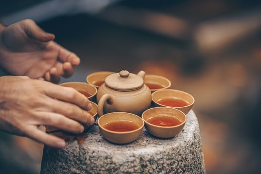 The Art of Ceremonial Tea Pouring Amidst the Beauty of Natures Scenic Landscapes photo