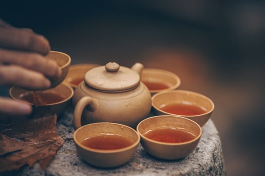 The Art of Ceremonial Tea Pouring Amidst the Beauty of Natures Scenic Landscapes photo