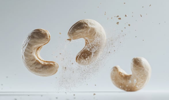 Three cashews are flying through the air photo