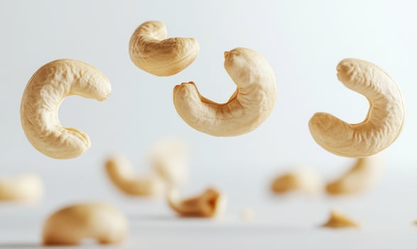 Three cashews are flying in the air photo