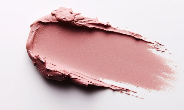 A pink blob of makeup is on a white background photo