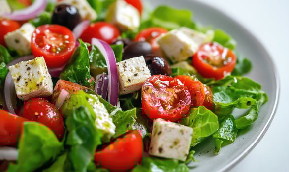 a salad with tomatoes, onions, feta cheese and red onions photo