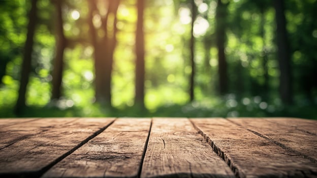 A wooden table with a view of a forest photo