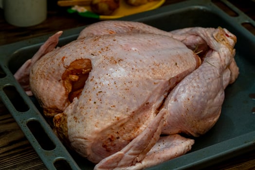 Whole turkey prepared for roasting during holiday gathering photo