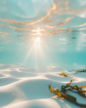 Sunlit ocean underwater scene with light rays and rippling sand photo
