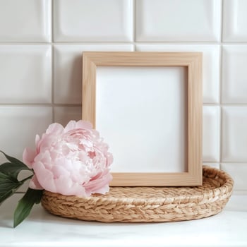 Elegant blank picture frame with peony flower on a textured background photo