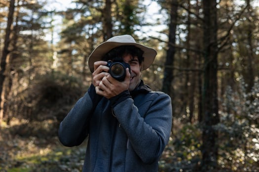 Explorer Capturing Forest Moments with Camera photo