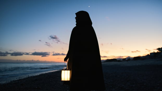 Monk With Black Dress Looking Up At The Sky photo