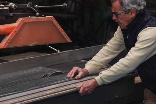 High-Risk Task Elderly Carpenter Operating Electric Circular Saw on Large Wood Plank photo