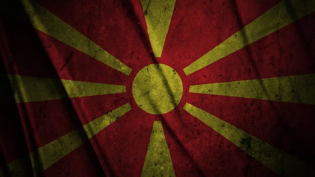 North Macedonia grunge silk flag waving in the wind background illustration, grunge textured flag on silk photo