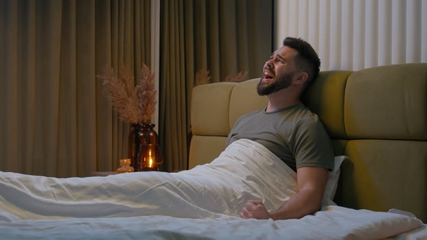 Frustrated man sitting bed screaming despair loss failure divorce separation emotional nervous breakdown displeased anger problem irritation distraught cry anxiety sorrow stress home bedroom desperate photo