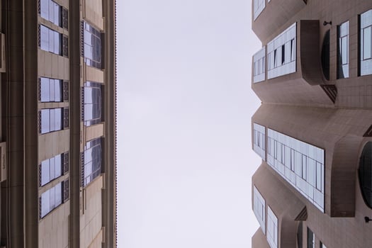 Looking up at the sky between two tall buildings photo