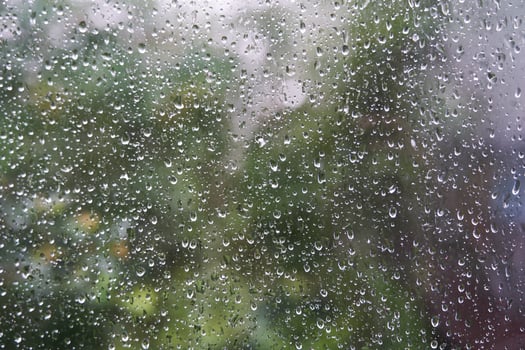 Transparent blurred window on the background of nature with raindrops. With copy space photo