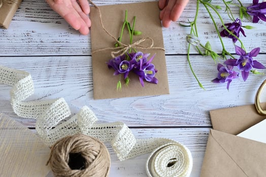 Pink and blue flowers, postcard, kraft, twine. Layout of Women's Day or Mother's Day, St. Valentine's Day, flat, top view. photo