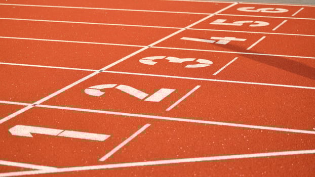 The red runway is numbered at a stadium photo