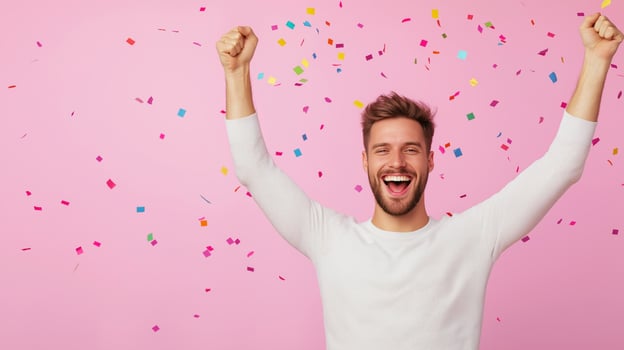 Happy man celebrating with colorful confetti on a pink background. Festive and joyful celebration concept. photo