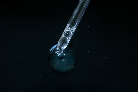 Pipette drop on black background photo
