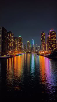 Stunning city skyline illuminated at night reflecting on water surface in urban area photo