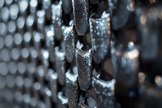 A close up of a metal mesh with holes photo