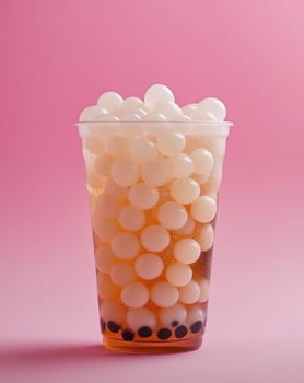 Bubble tea with white balls on pink background photo