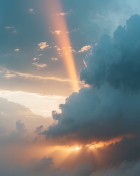 Glowing sunbeam breaks through stormy clouds during a dramatic sky transition at sunset photo
