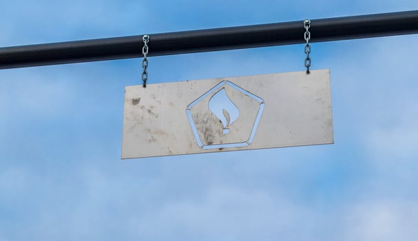 Metal plate with fire or gas sign engraved in it. Concept photo