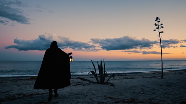 Shadowy Monk Seeks Secrets by the Sea photo