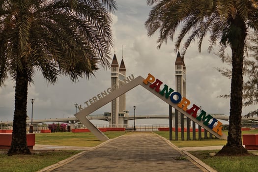 A stunning photogenic Kuala Terengganu drawbridge under a dramatic cloudy sky with structure featuring twin towers and a modern design that nestled against the ocean below. photo