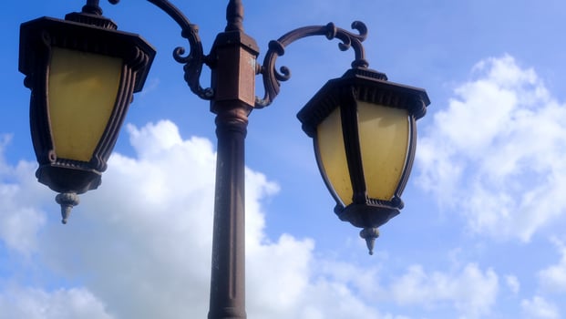 Retro style street lamp, blue sky and white clouds photo