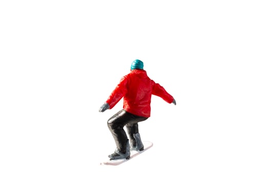 Miniature figurine depicting a snowboarder in mid-motion isolate on white background with clipping path photo