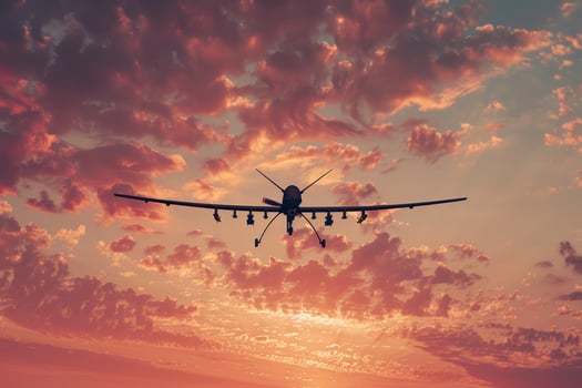 A large airplane flying in the sky at sunset photo