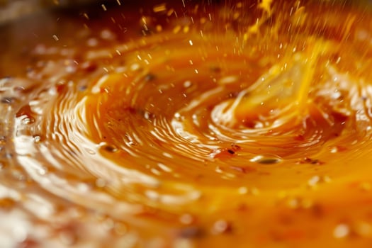 A swirl of yellow sauce is pouring out of a container photo