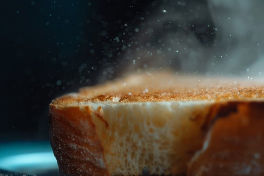 A slice of bread with a lot of steam coming out of it photo