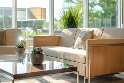 A modern office with a large window and two couches photo