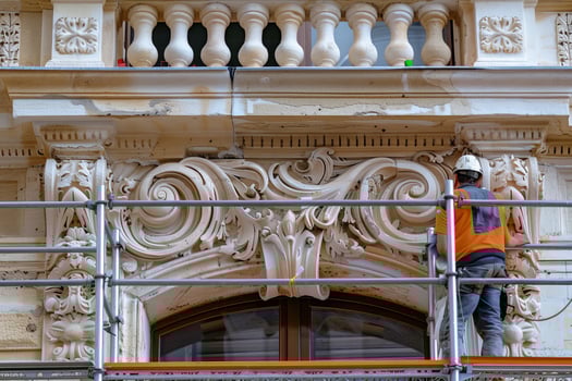 A man is working on a building with a scaffold photo