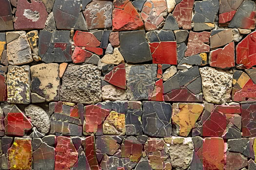 A wall with many different colored stones photo