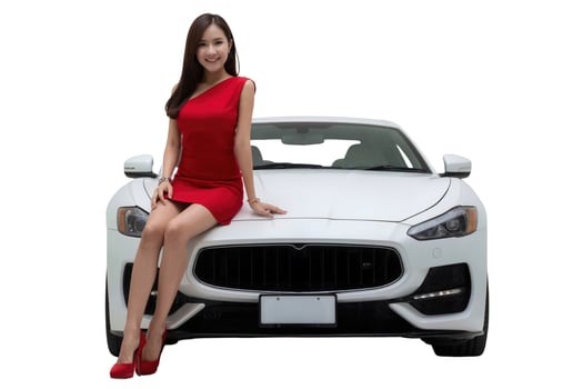 Asian woman in red dress and heels, smiling beside a white sports car, in a studio setting. photo