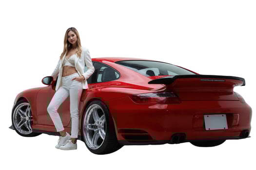 A photograph of a slender woman in a white suit standing beside a red, luxury sports car. photo